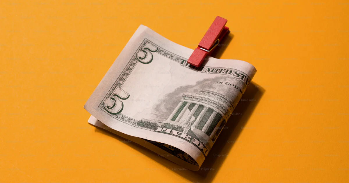 A piece of paper with a red pin sticking out of it photo ā Finance ...