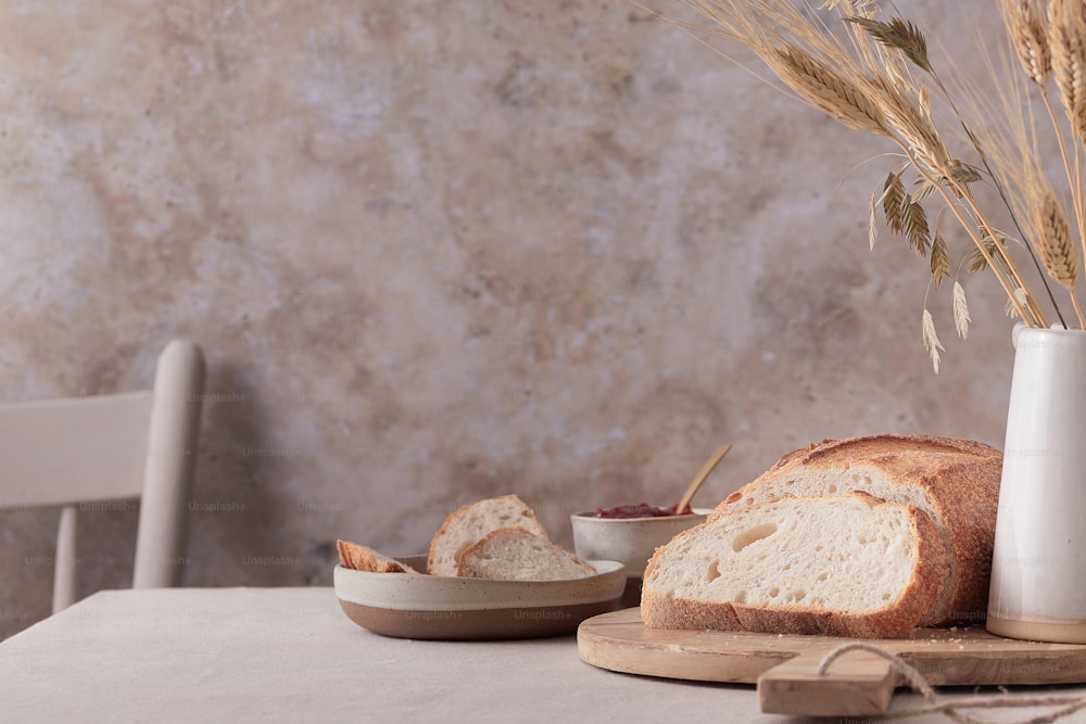 a loaf of bread sitting on top of a wooden cutting board