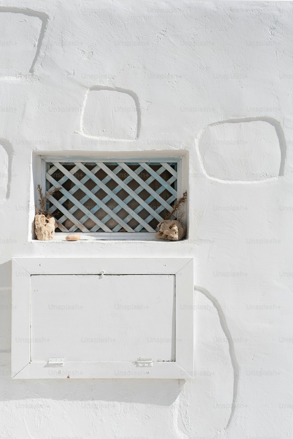 a white wall with a small window in it