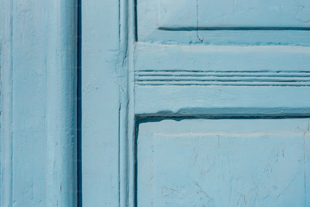a close up of a blue door with a stop sign