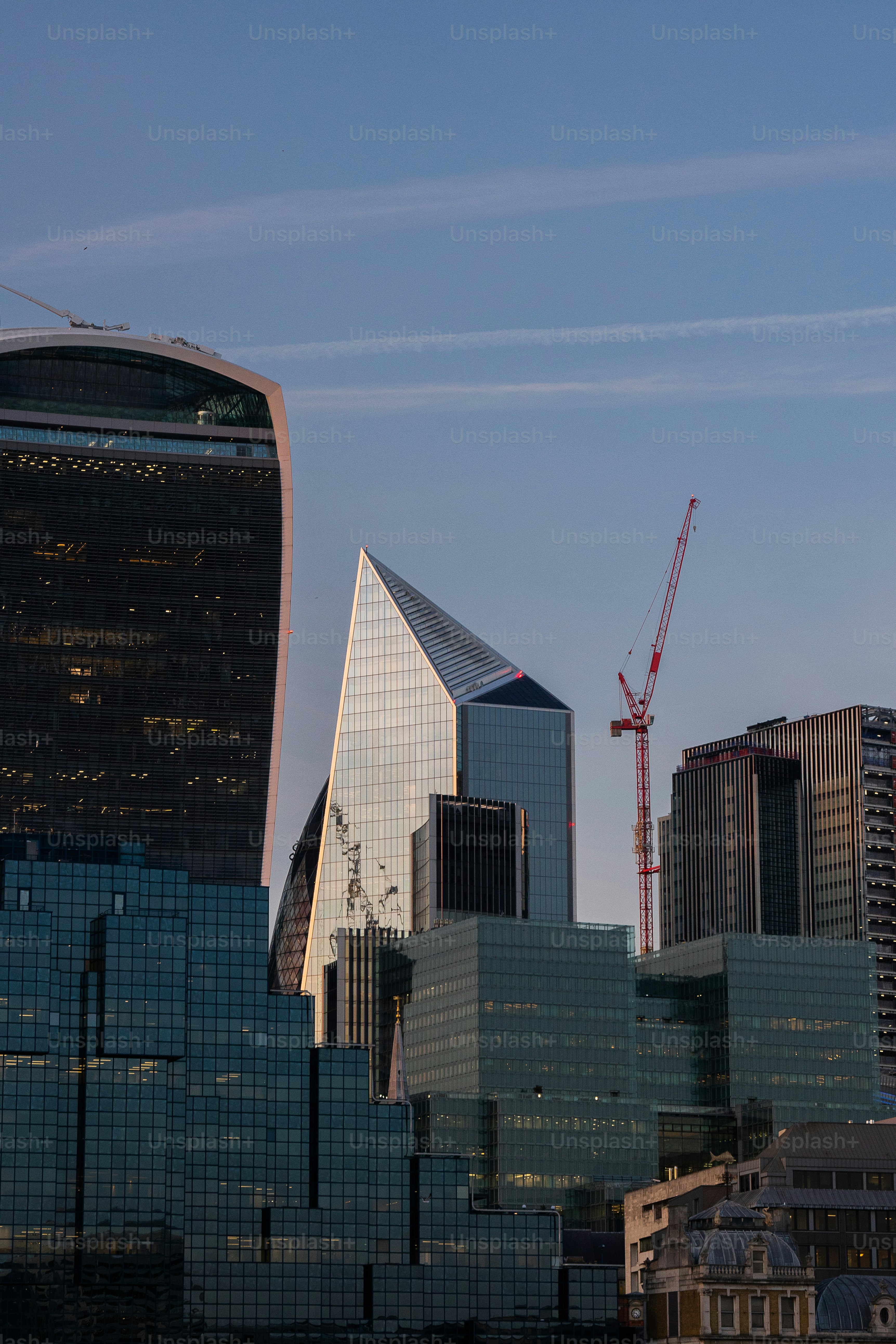 a city skyline with a crane in the background
