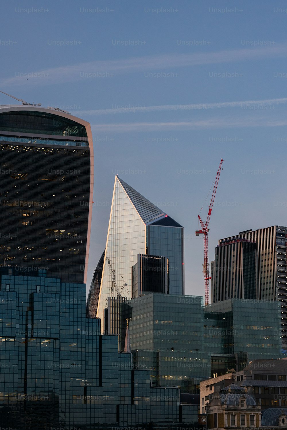 a city skyline with a crane in the background