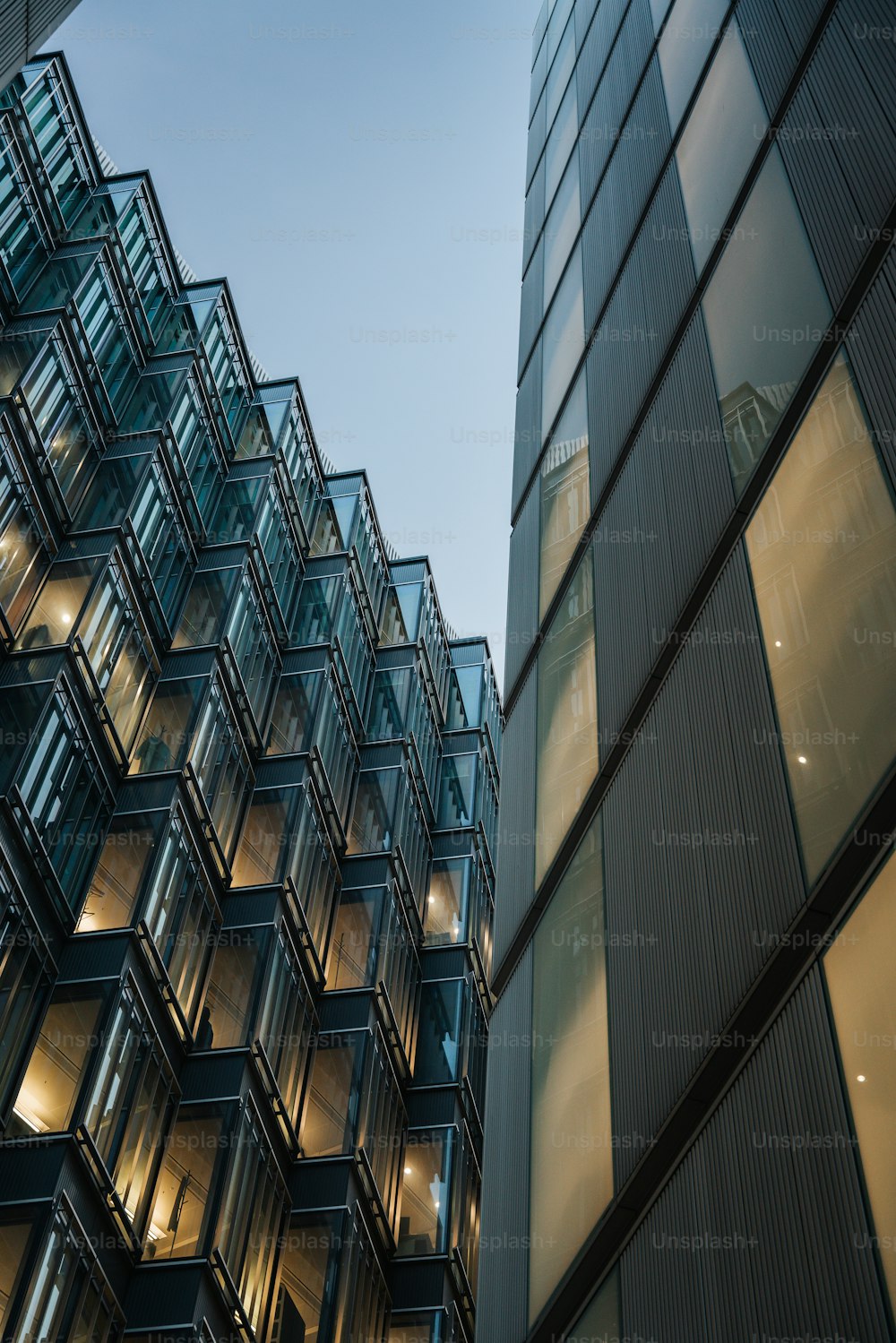 a tall building with lots of windows next to another building