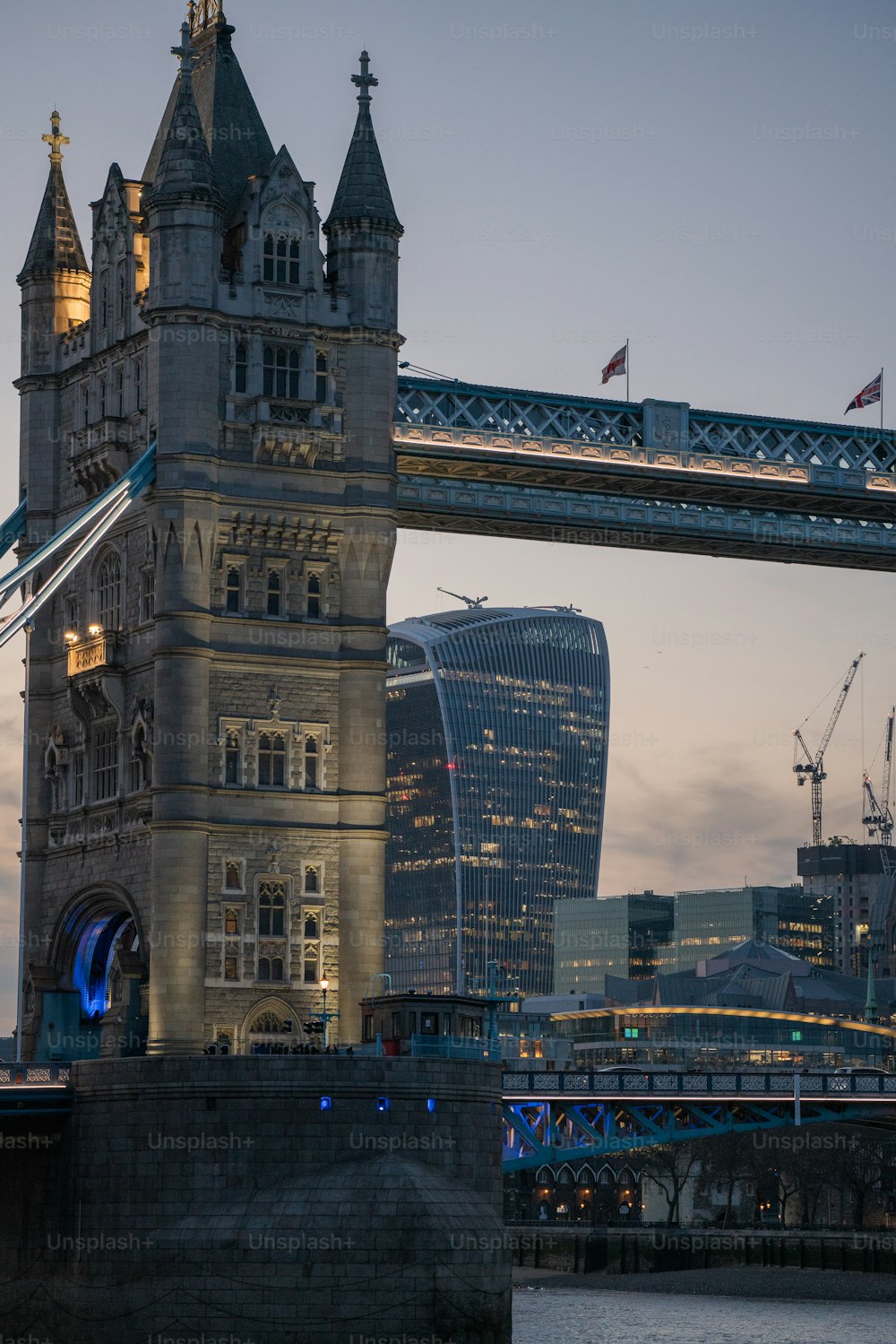 a tall tower with a bridge in the background