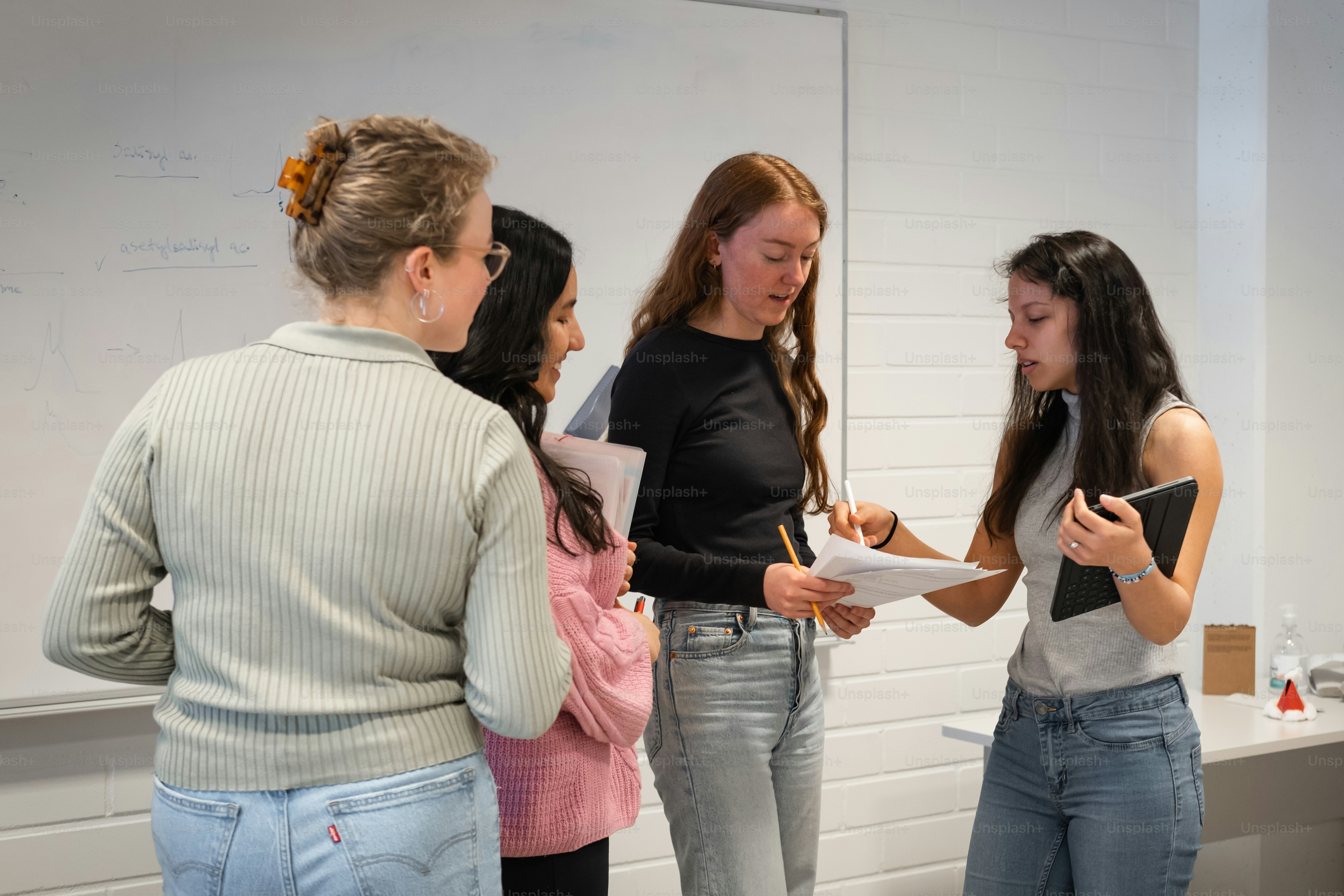 a group of young women standing next to each other