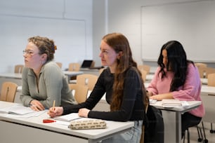 a group of women sitting at desks in a classroom