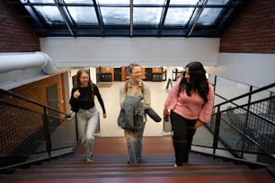 a group of women walking down a flight of stairs