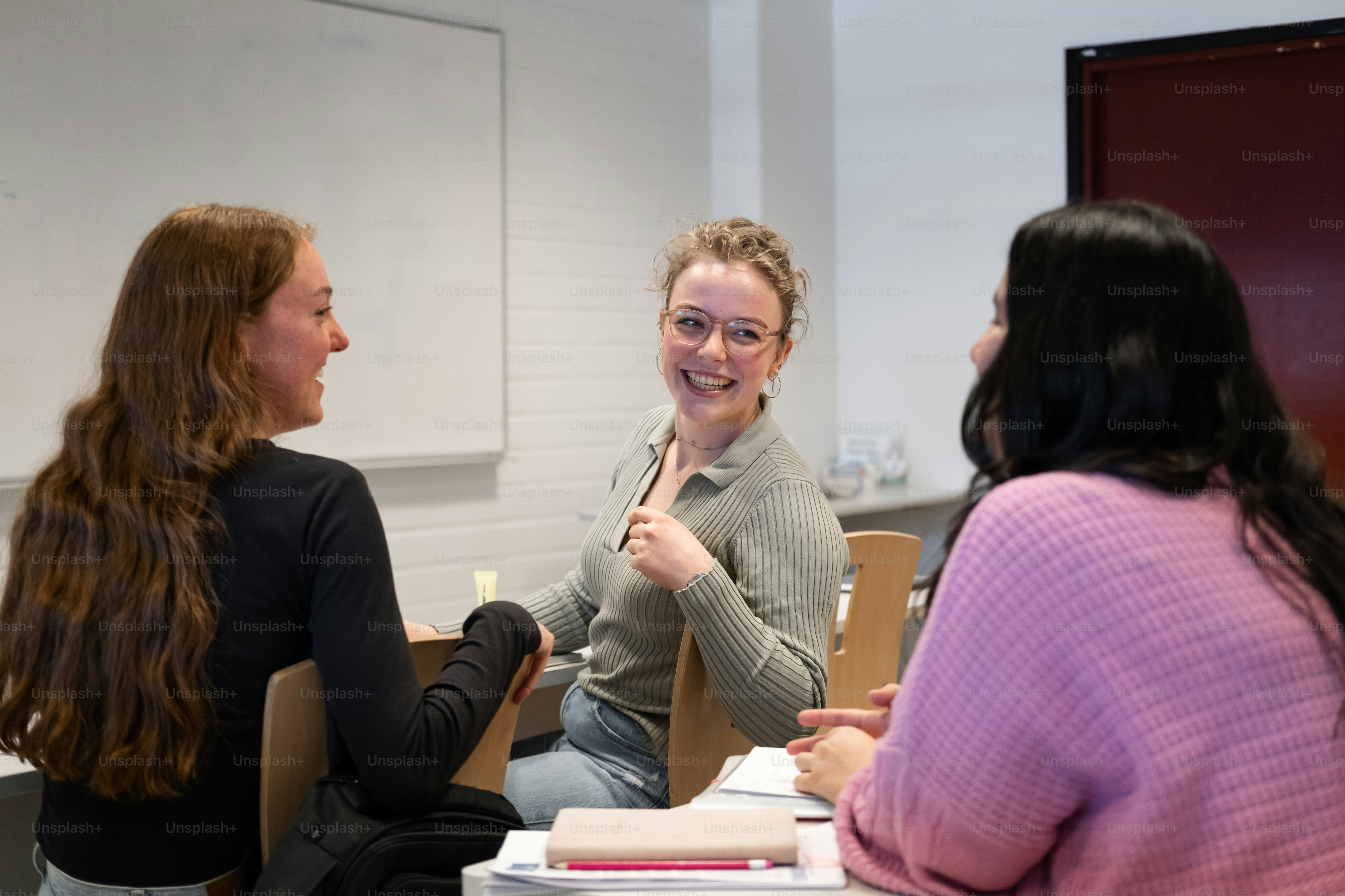 a group of women sitting around a table talking