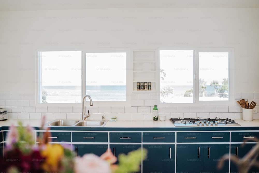 a kitchen with a sink and a stove top oven