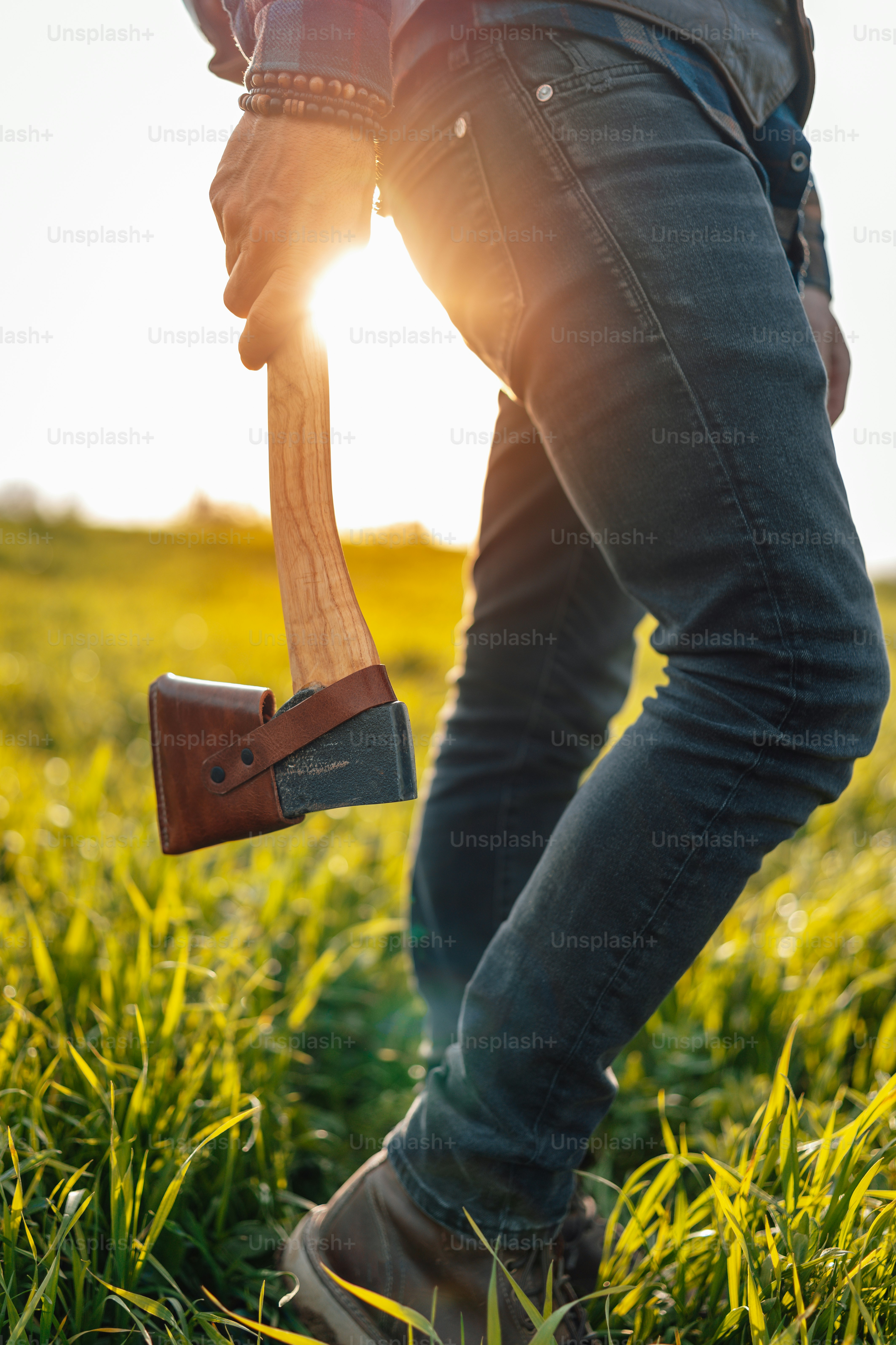 a person standing in a field holding a shovel