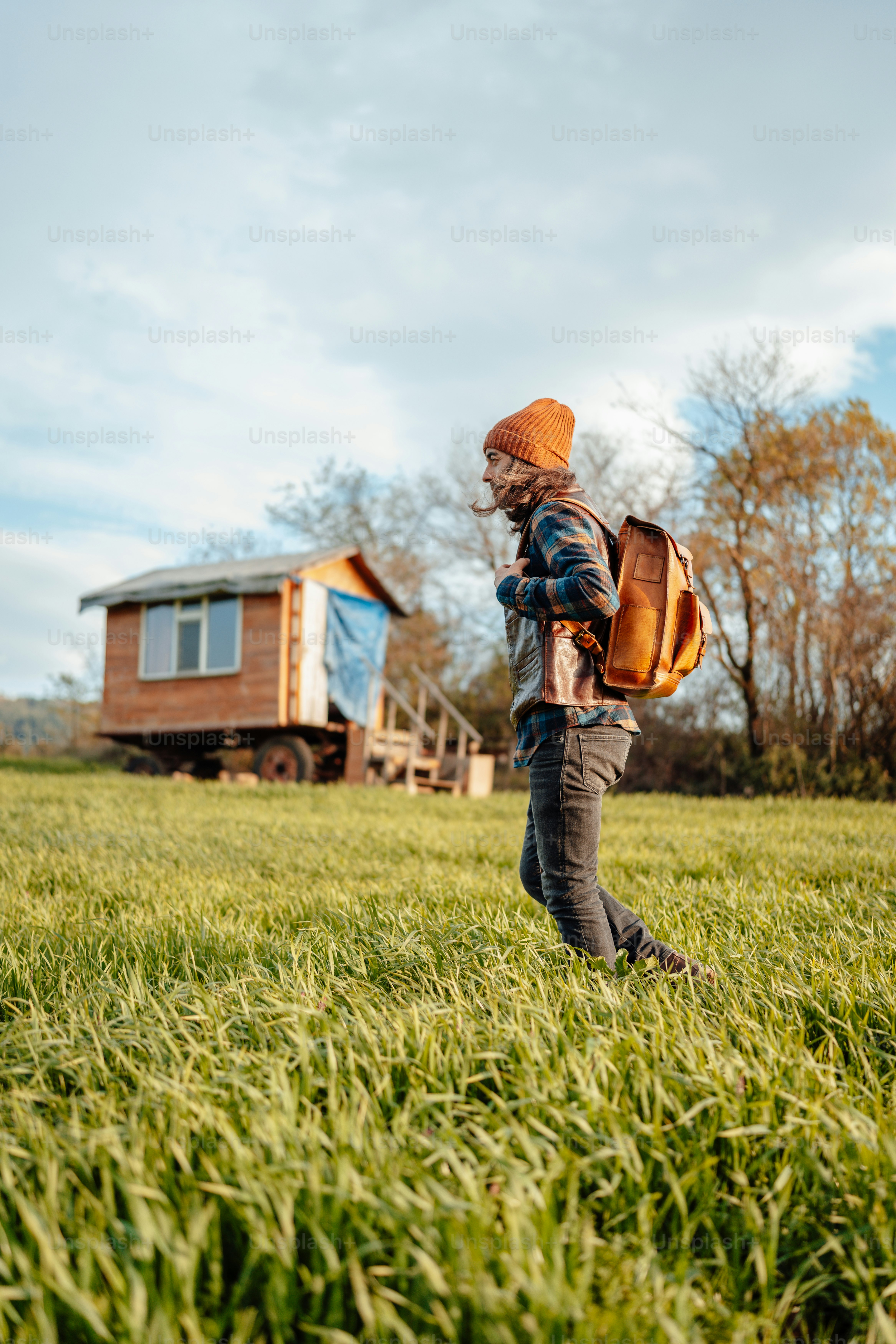 a person with a backpack walking through a field