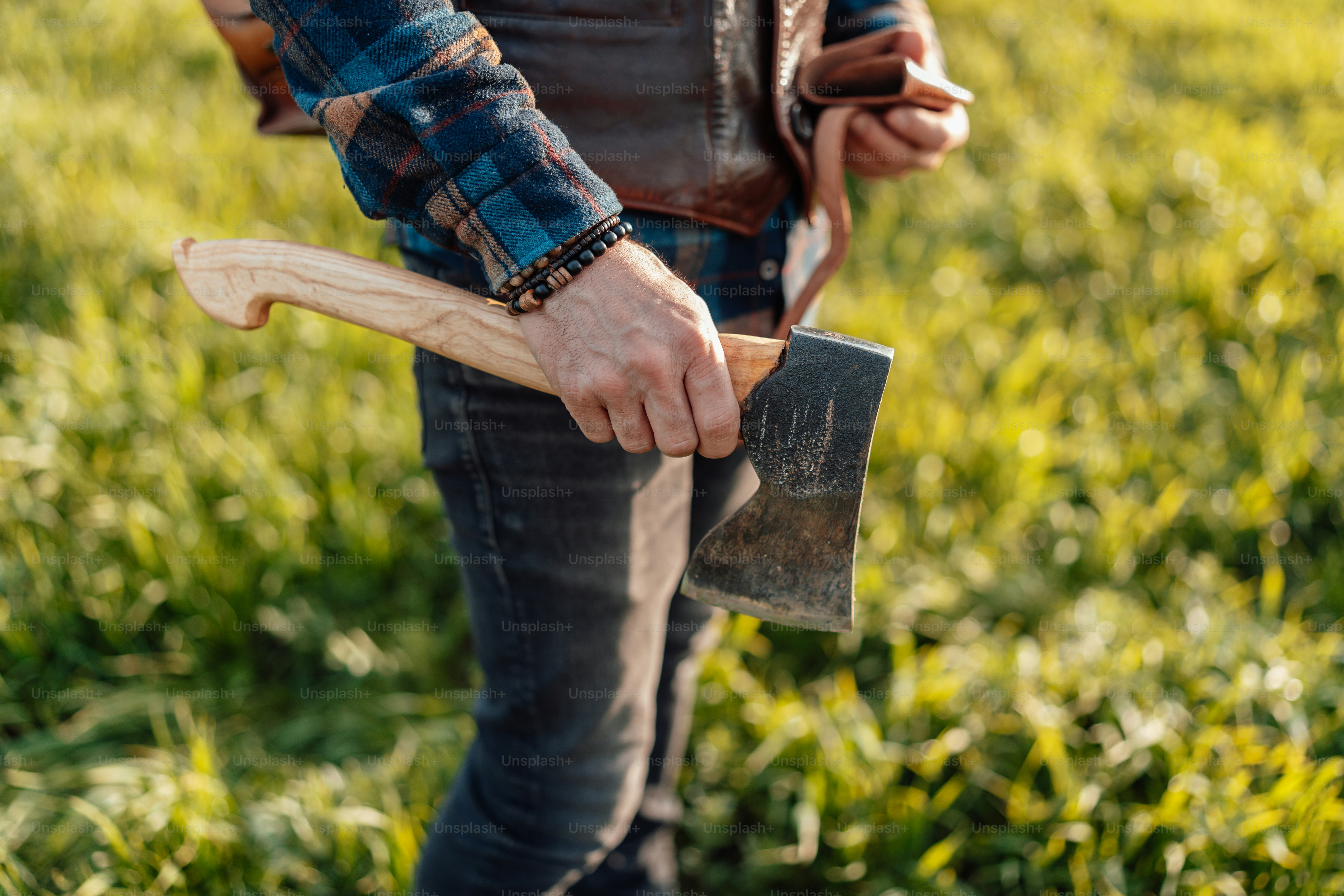 a man holding a shovel and a pickle in a field