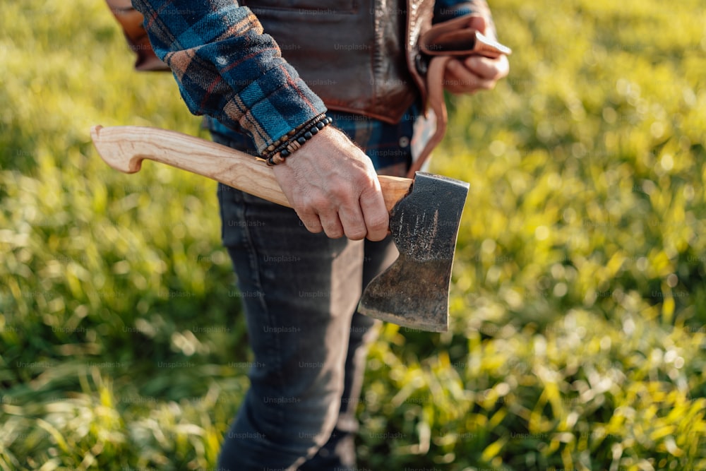 a man holding a shovel and a pickle in a field