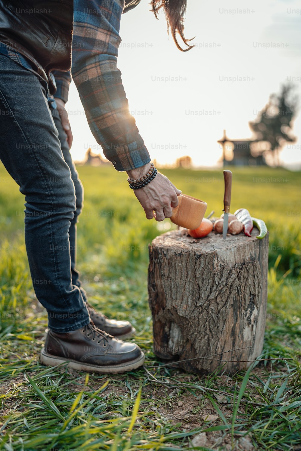 a person standing next to a tree stump