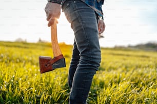 una persona in piedi in un campo con una pala in mano