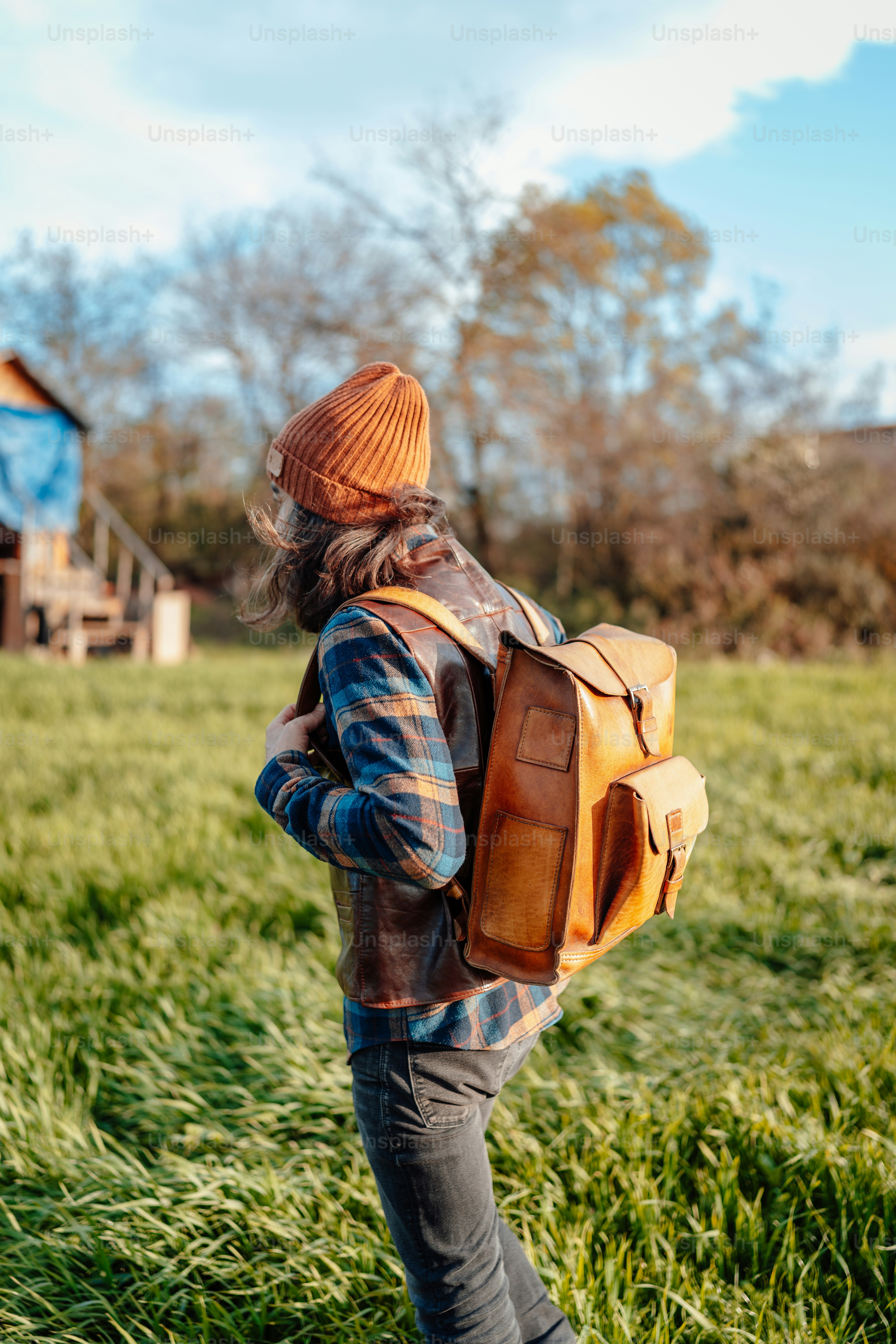 a person with a backpack walking through a field