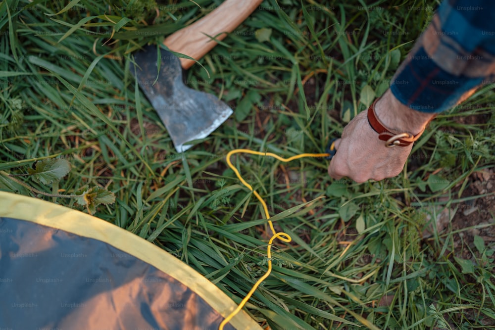 a person standing next to a yellow and blue tent