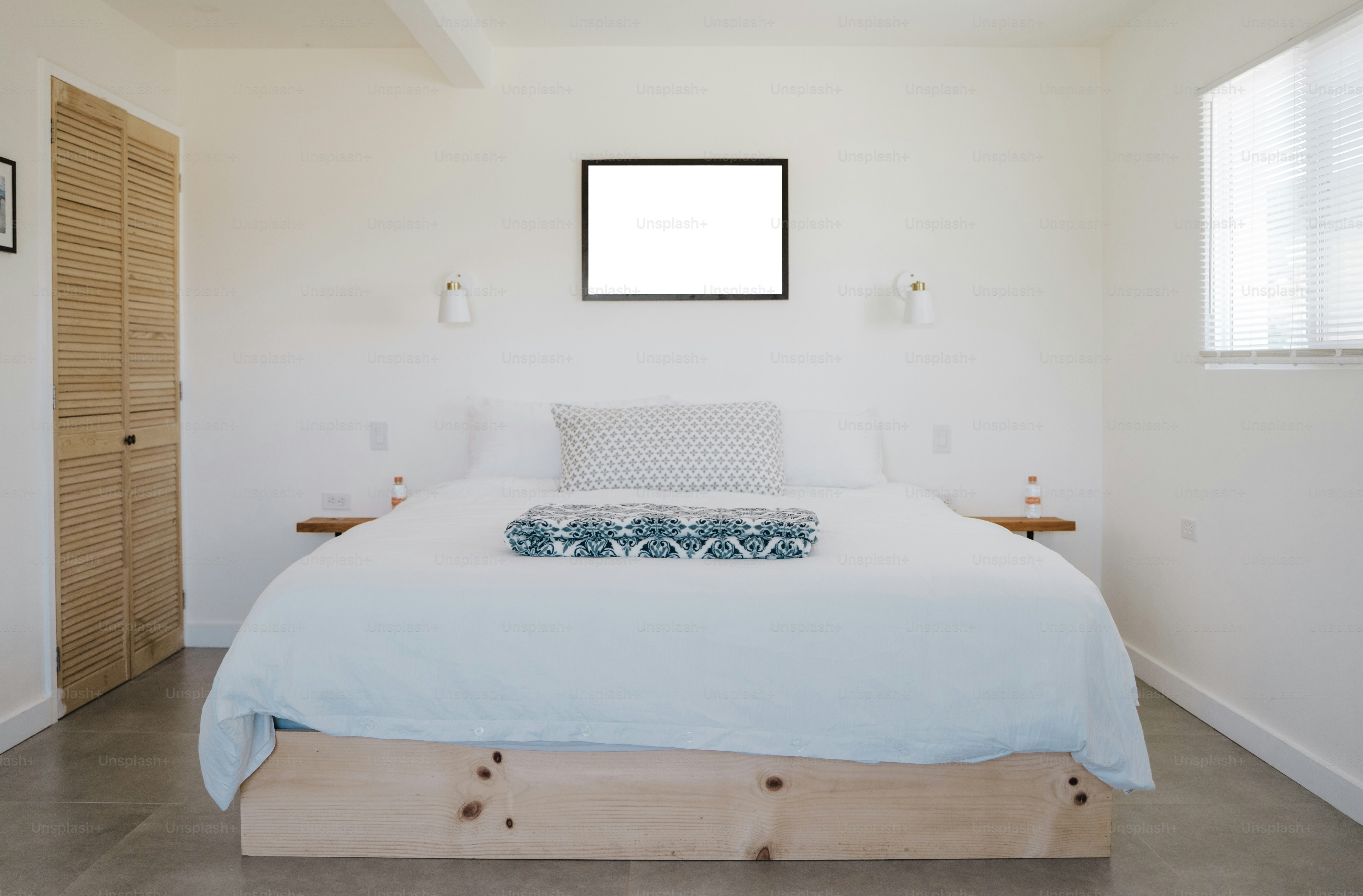A modern bedroom with soft blue lighting, a smart sleep tracker on the bedside table, and a digital sleep monitor projecting data on the wall.
