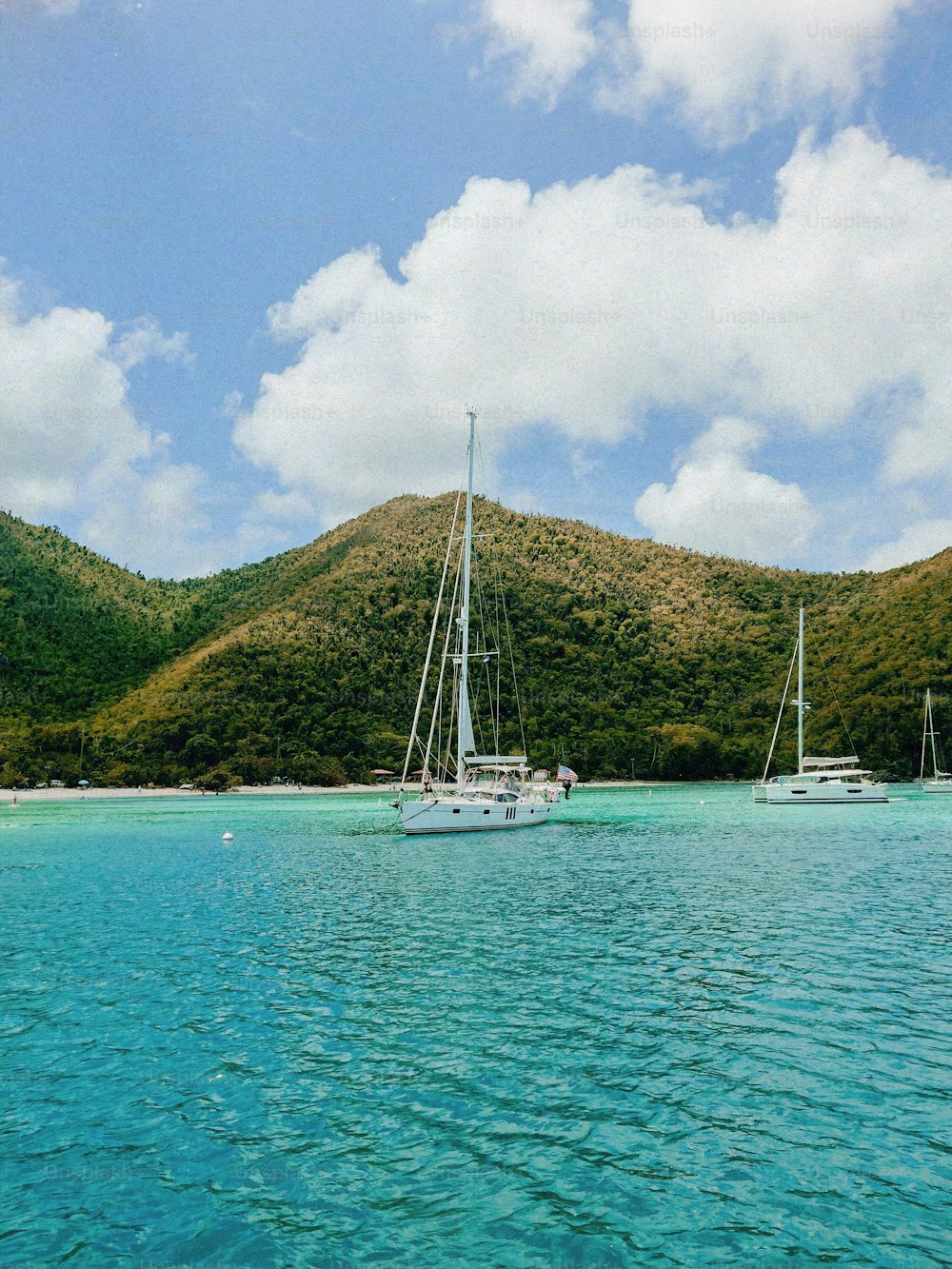 a couple of boats floating on top of a body of water