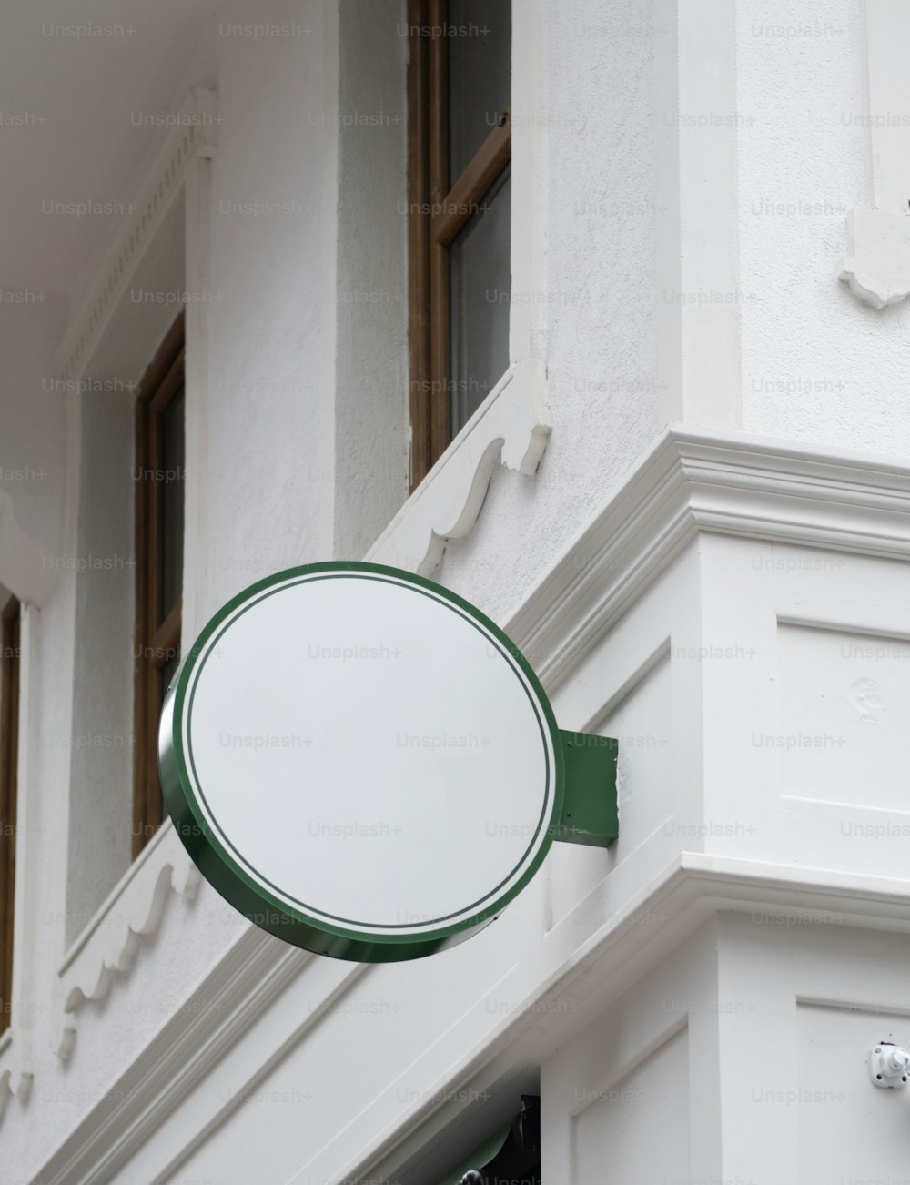 a round mirror mounted to the side of a building