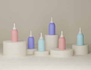 a group of different colored bottles sitting on top of each other