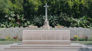 a memorial with a cross on top of it