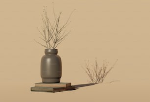 a gray vase sitting on top of a stack of books