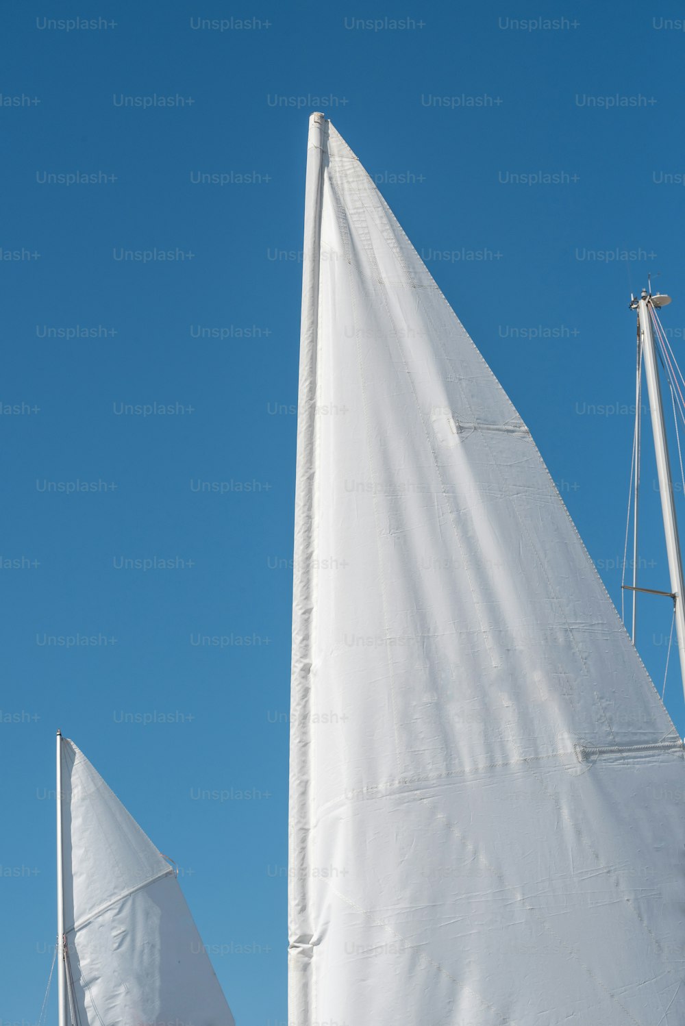 a couple of white sail boats sitting next to each other