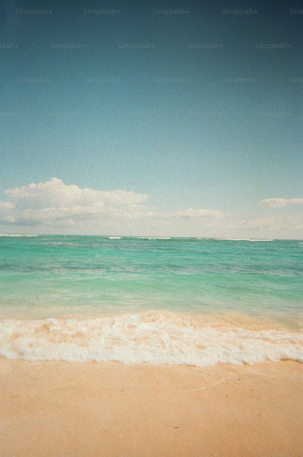 a view of the ocean from a sandy beach