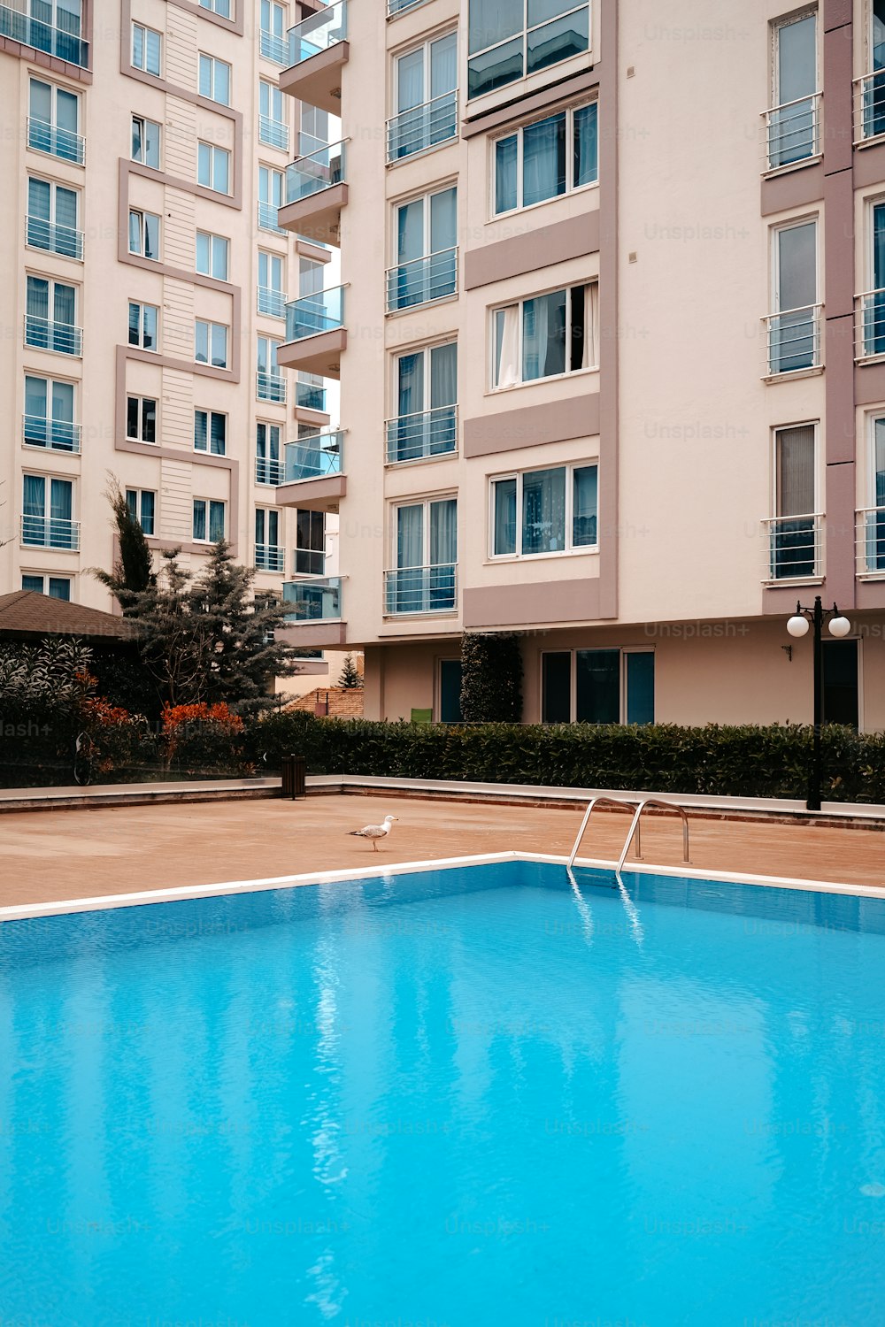 an empty swimming pool in front of a building