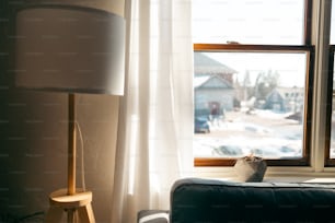 a living room with a lamp and a window