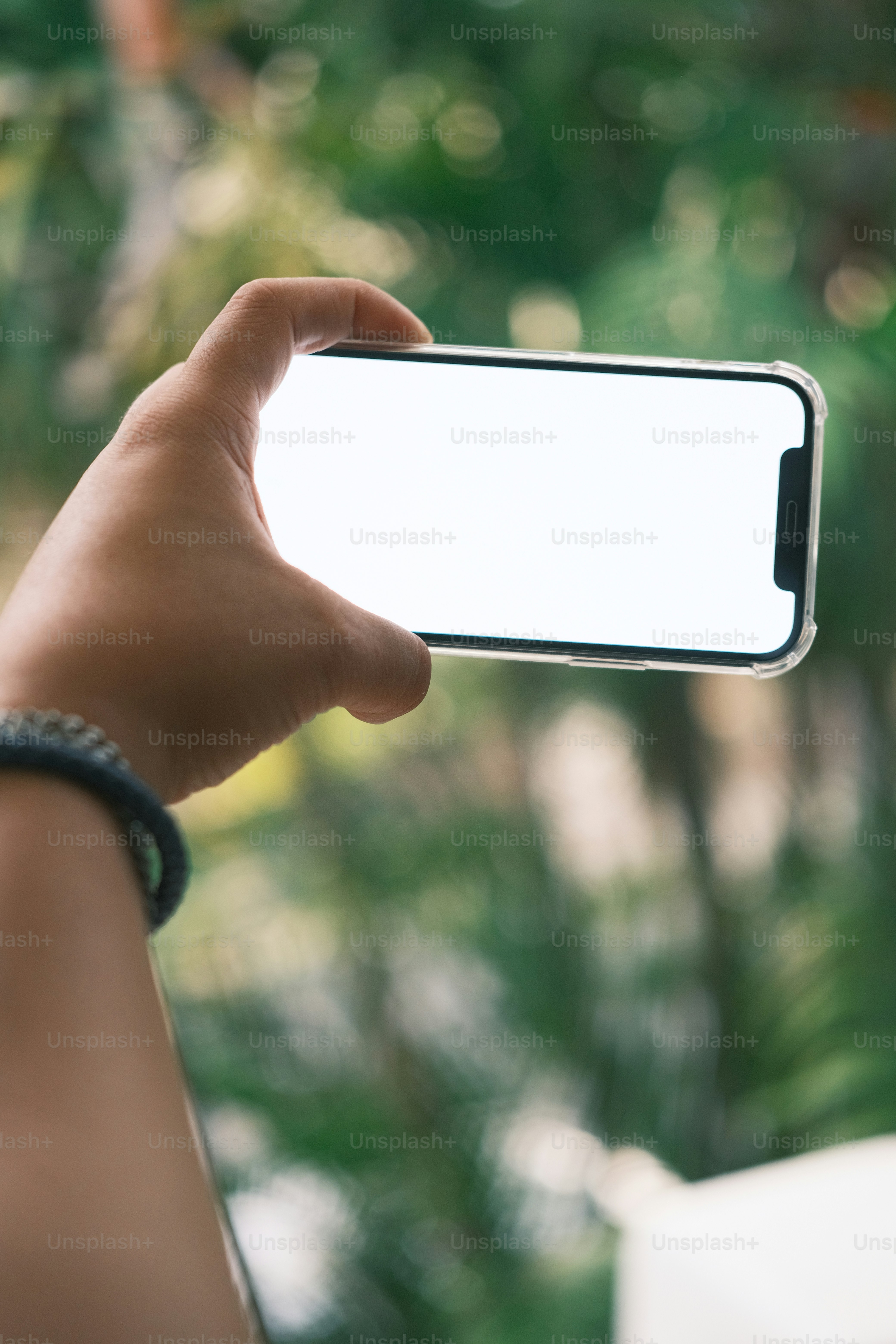 a person holding a cell phone in their hand