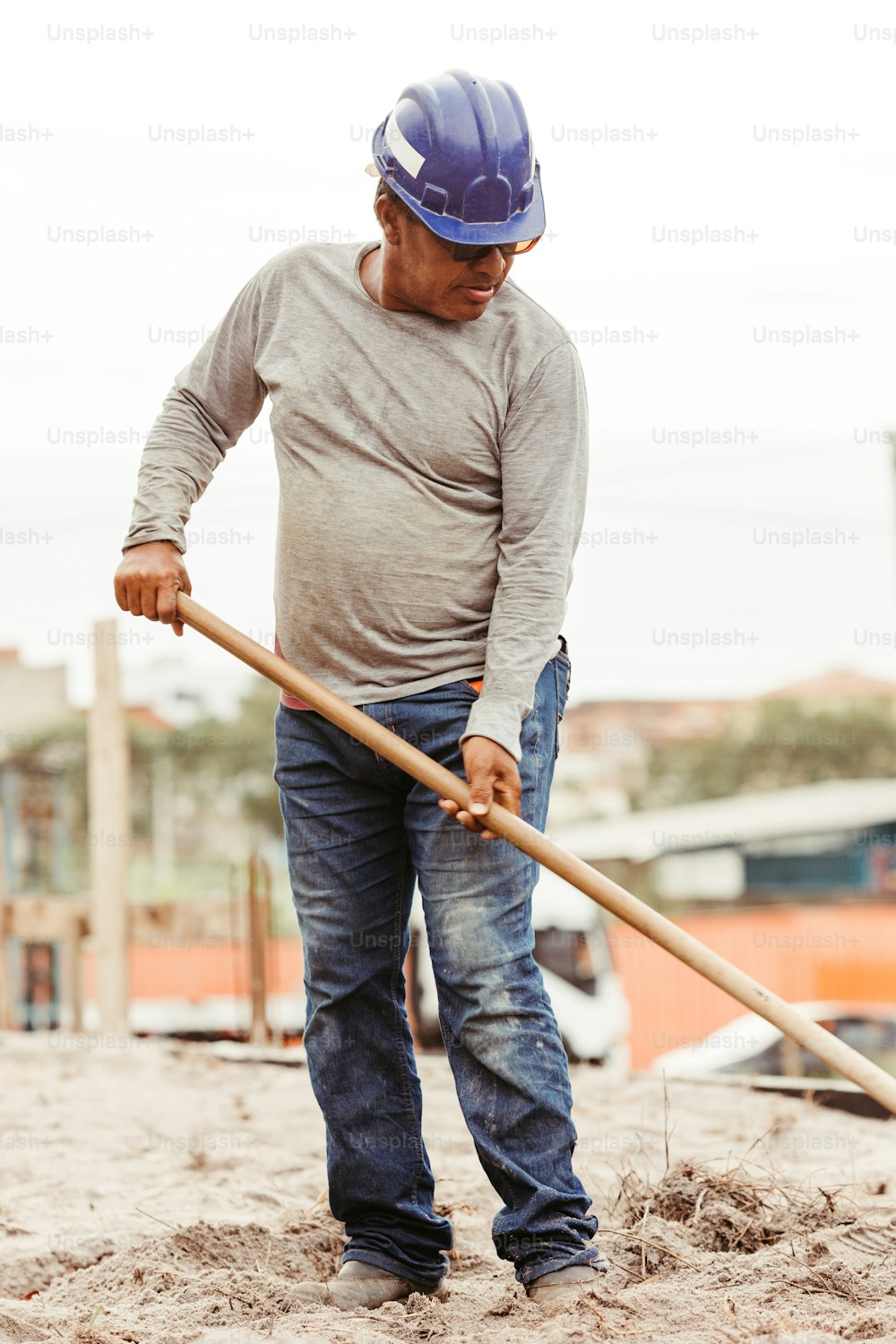 a man with a hard hat and a shovel