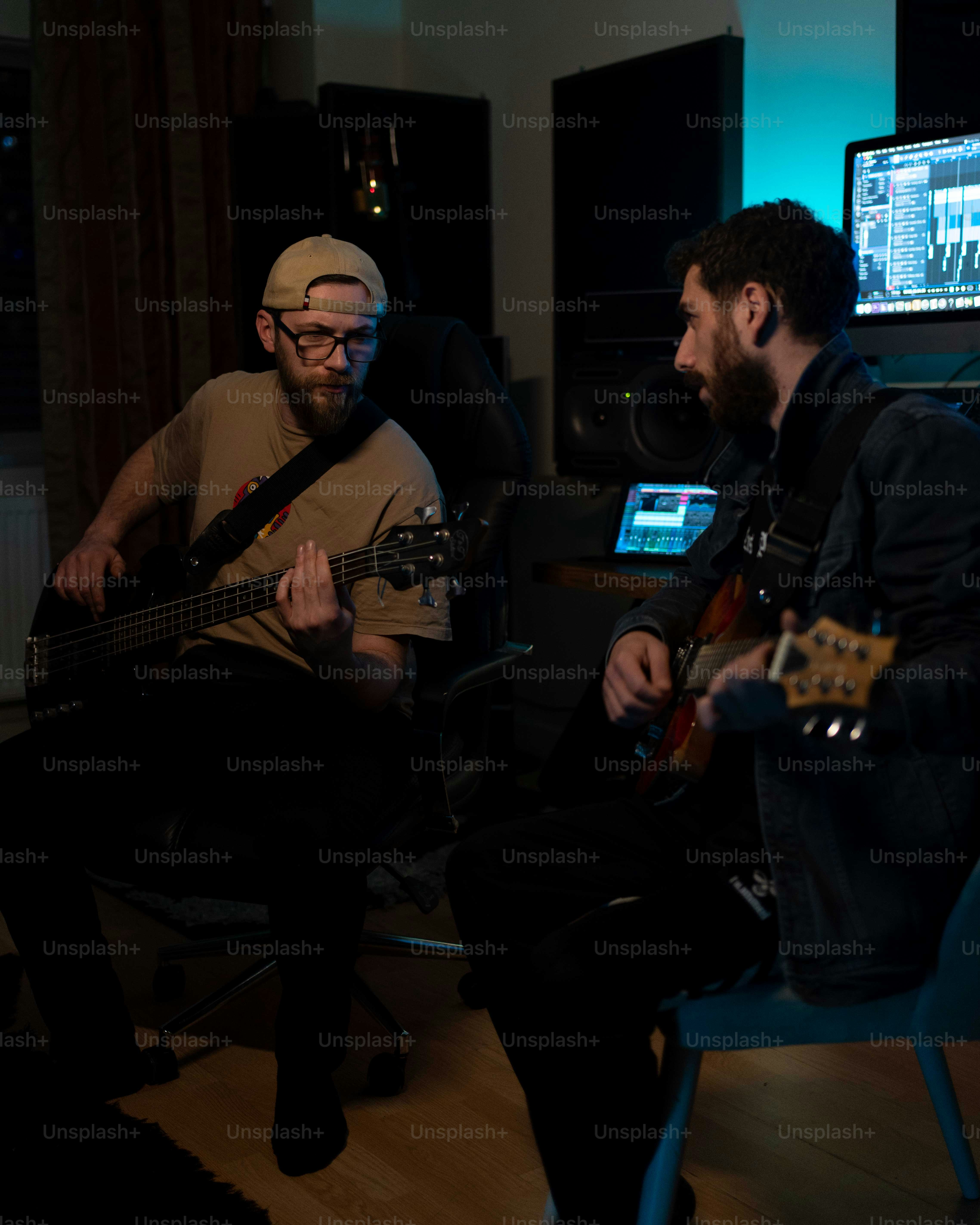 Bass player using drum tracks for bass practice in a home studio