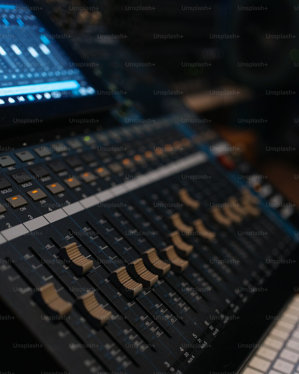 a close up of a sound mixing console