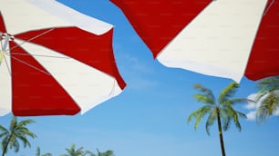 two red and white umbrellas and some palm trees