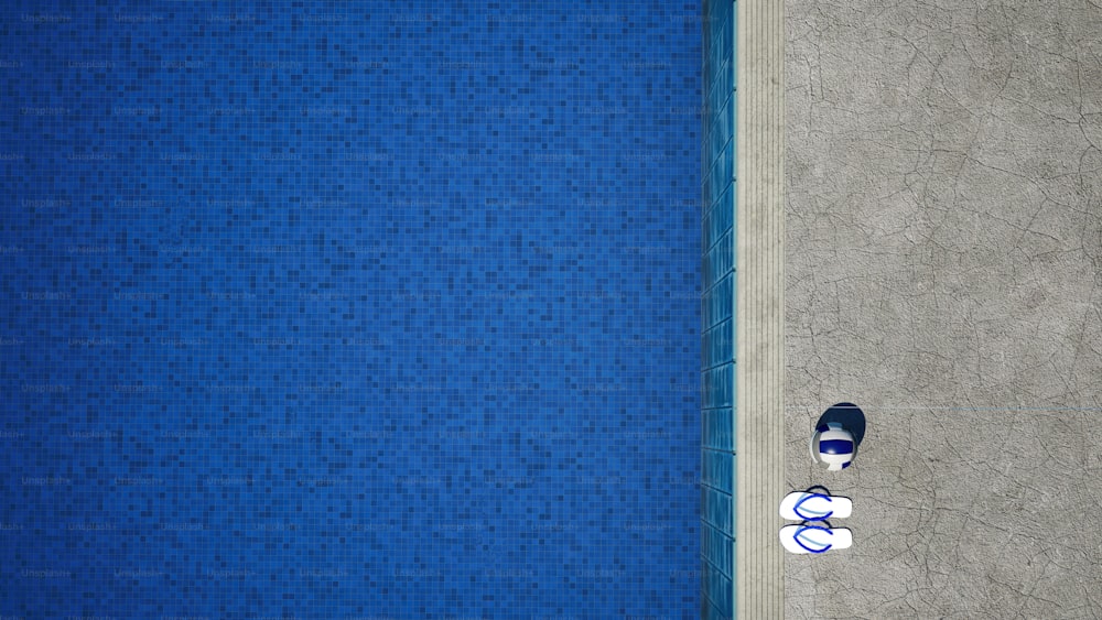 a person laying on the ground next to a swimming pool