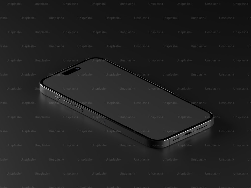 um telefone celular preto sentado em cima de uma superfície preta