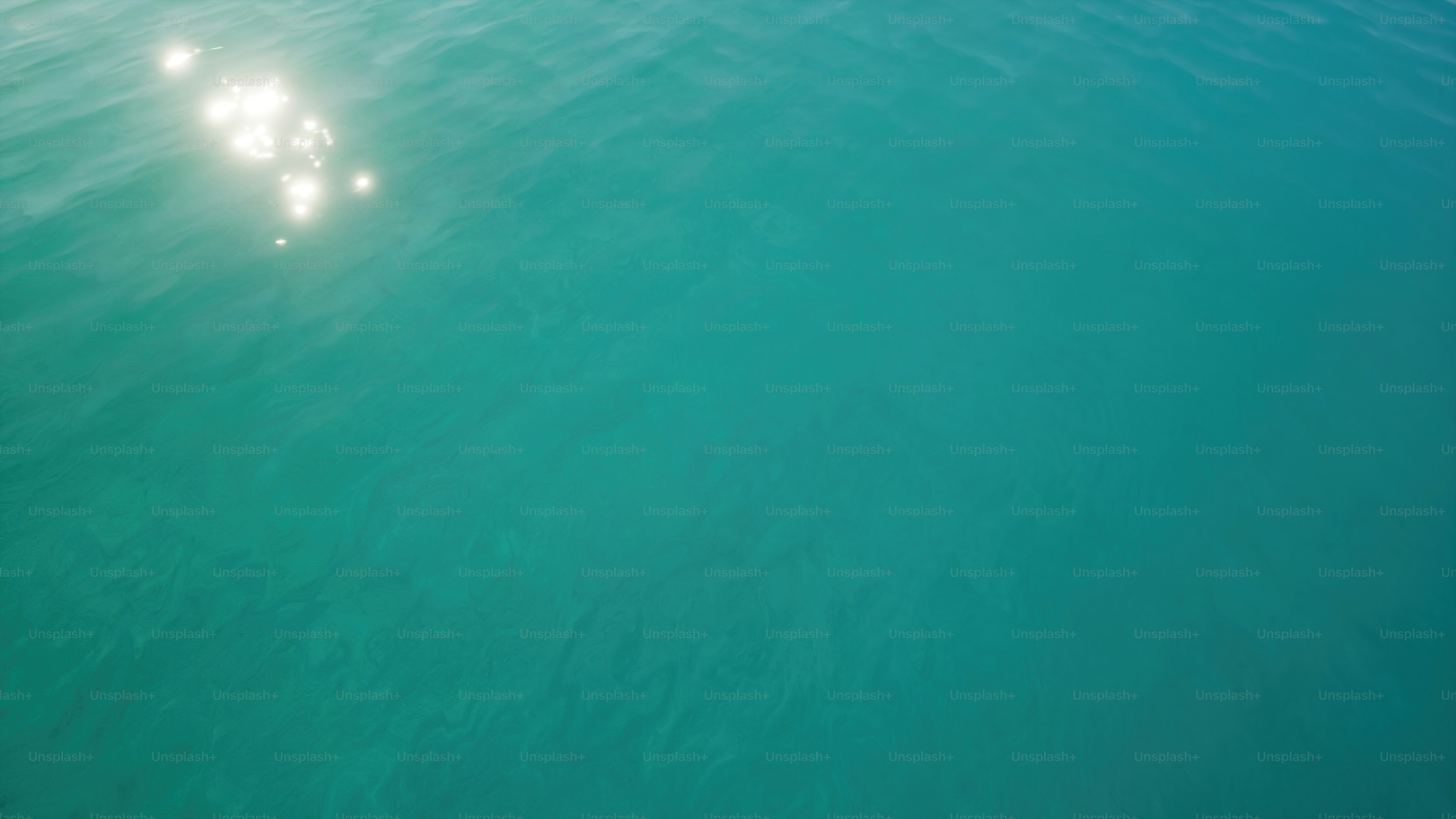 a couple of boats floating on top of a large body of water