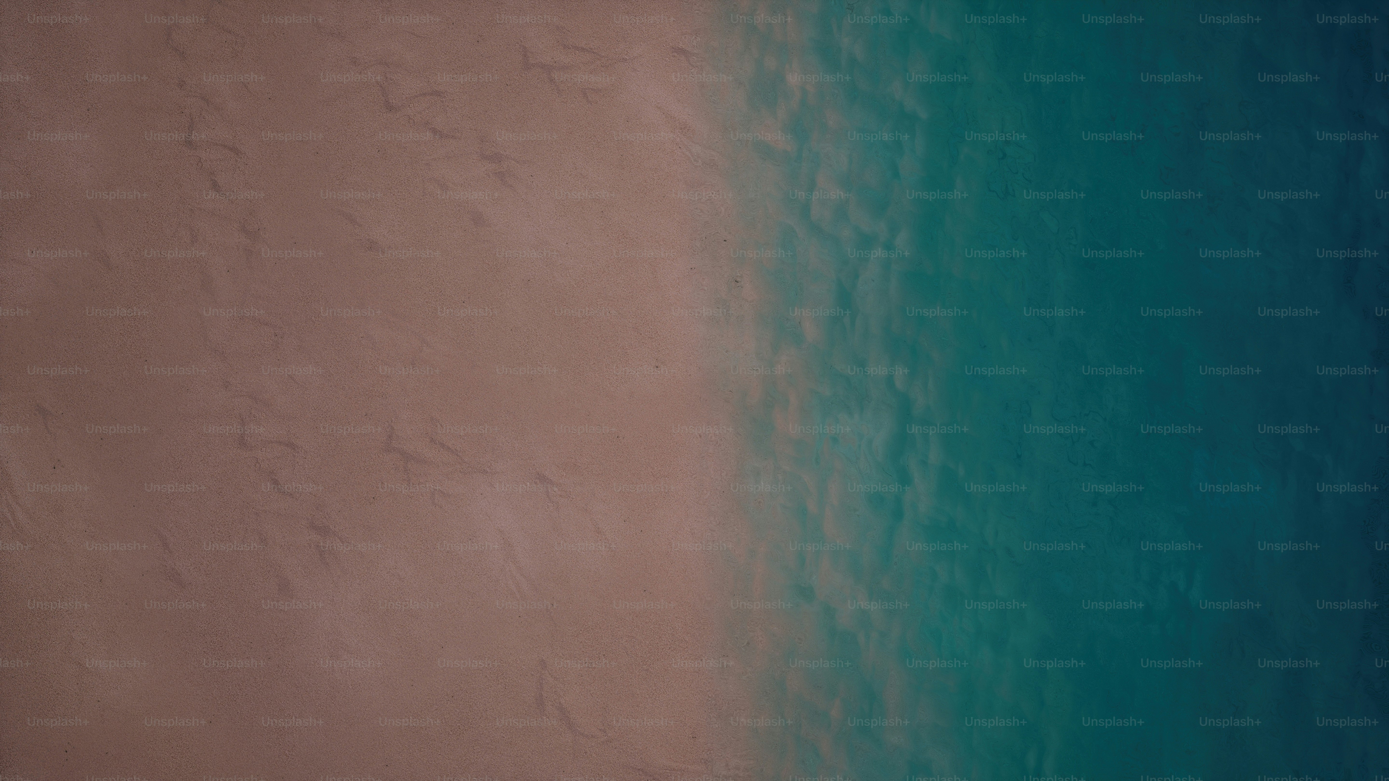 an aerial view of a sandy beach and ocean
