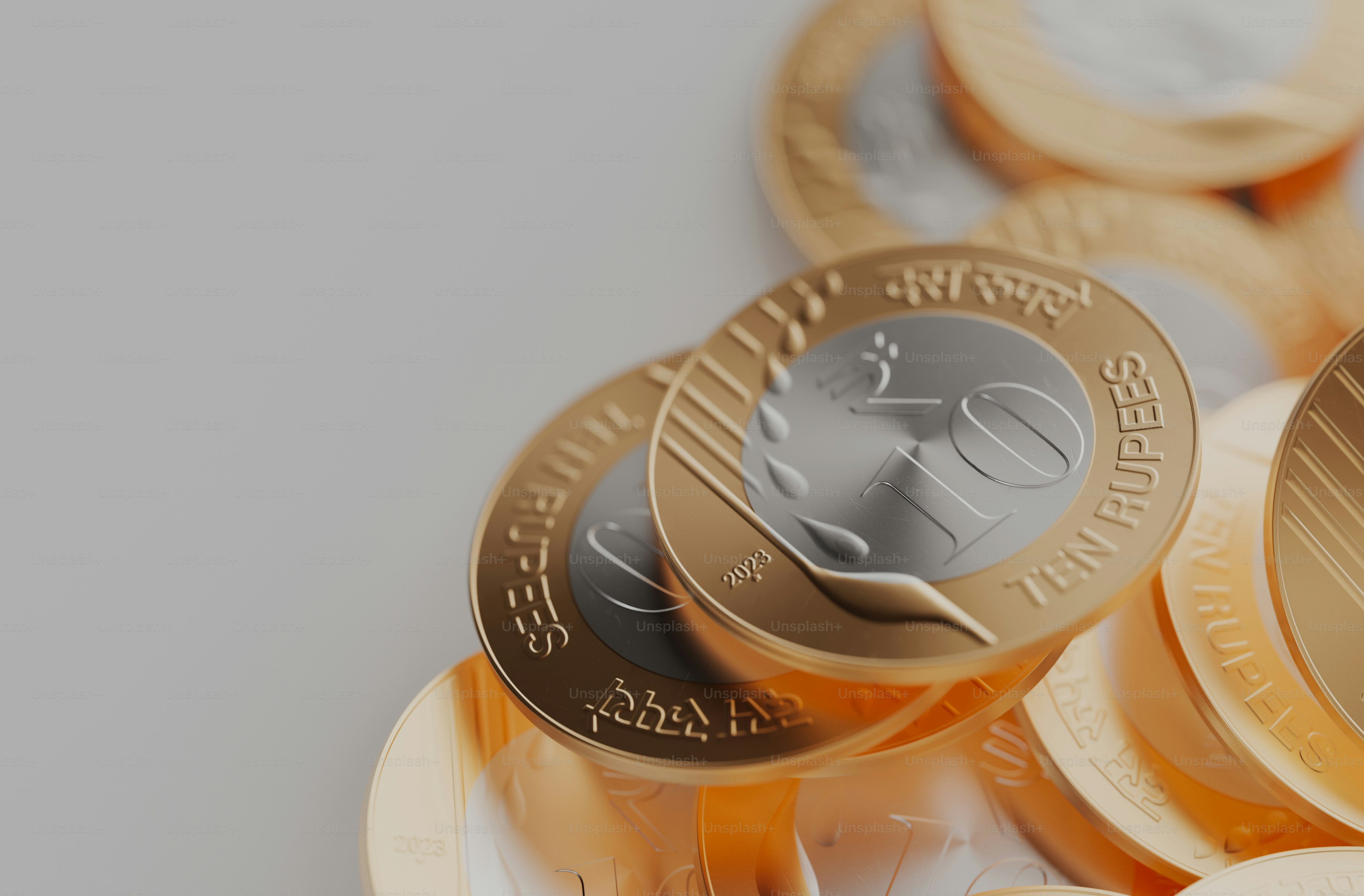 a pile of gold and silver coins sitting on top of each other