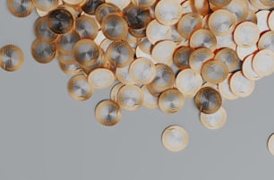 a pile of gold and silver coins on a gray background