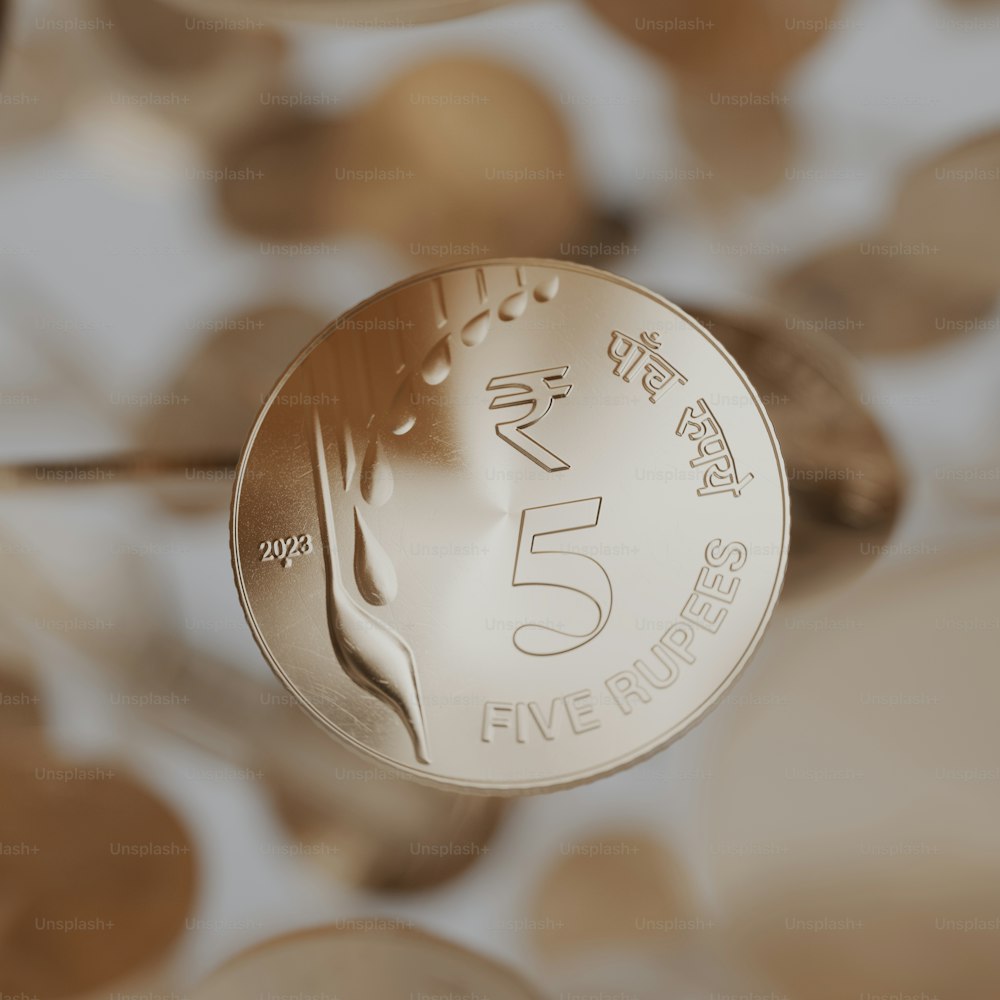 a close up of a five rupee coin