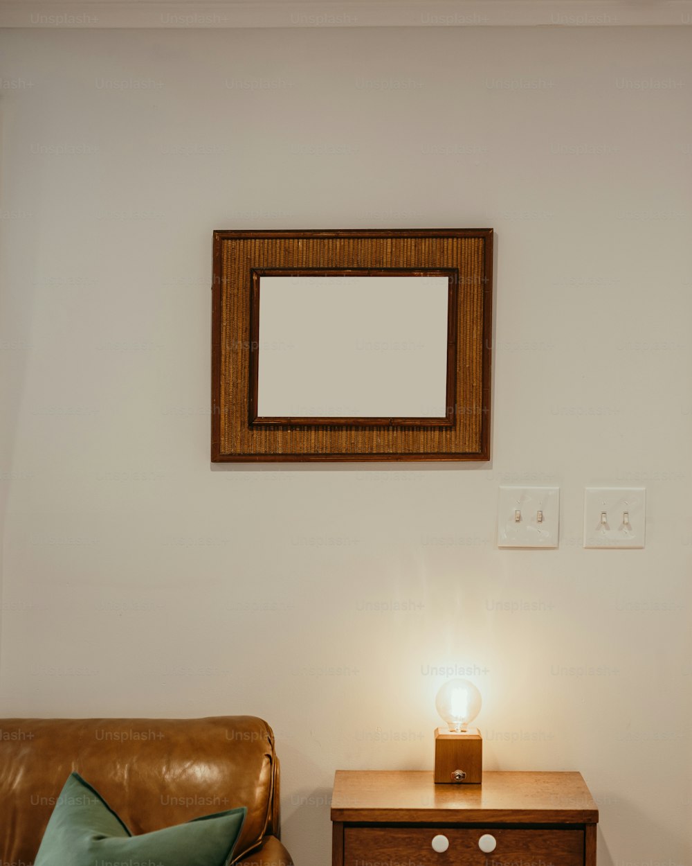 a living room with a leather couch and a wooden table