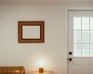 a small table with a lit candle in front of a white door