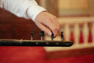a person playing a musical instrument with several knobs