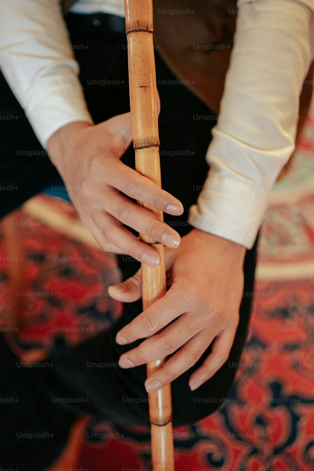 a person holding a bamboo stick in their hands