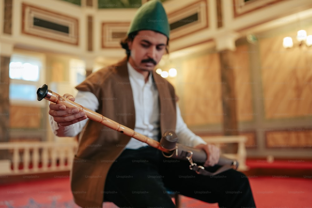 a man in a green hat is holding a baseball bat