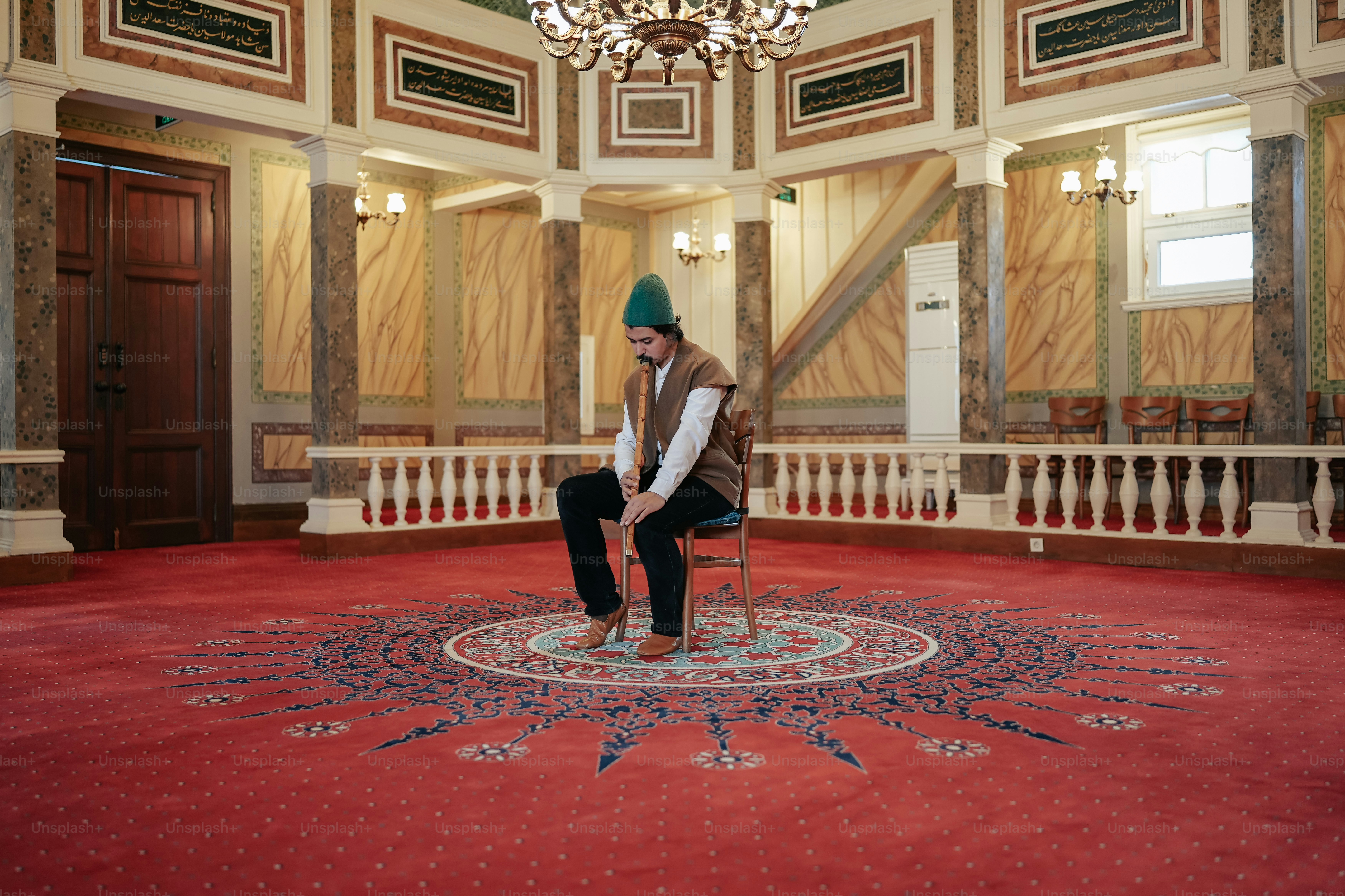 a man sitting on top of a chair in a room