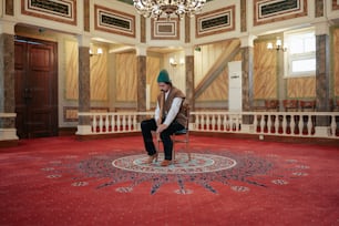 a man sitting on top of a chair in a room